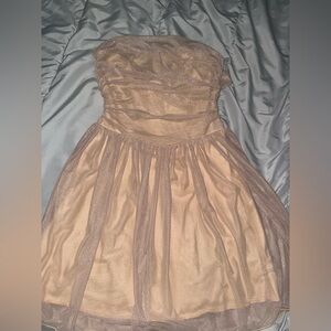 Gold flowy strapless dress with a bow in the back